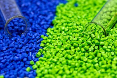 blue and green pellets spilling out of two clear vials
