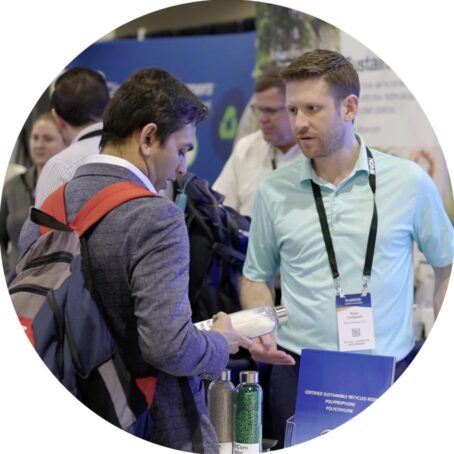 photo of two men talking at a trade show