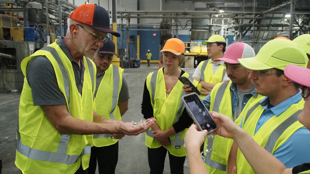 APR COO Curt Cozart and Design Training attendees in yellow vests on a recycler tour
