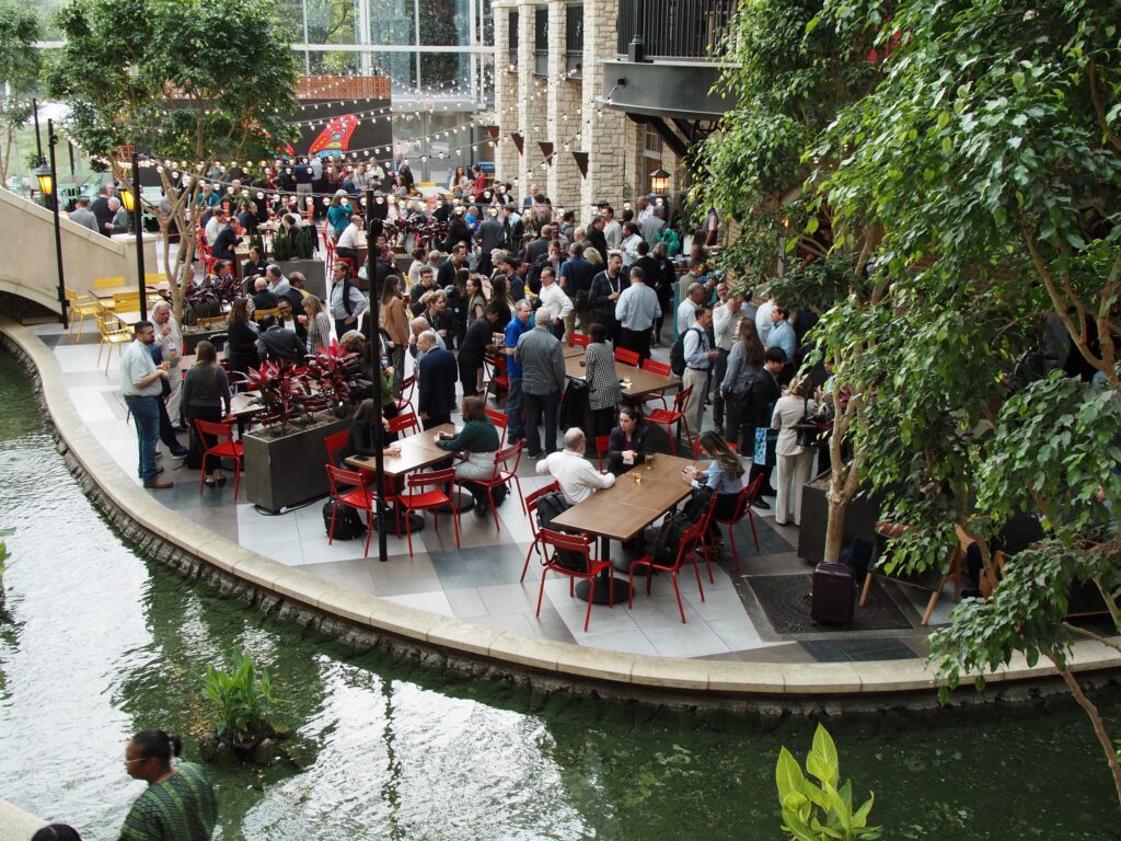 large gathering of people networking at the APR Spring Member Meeting
