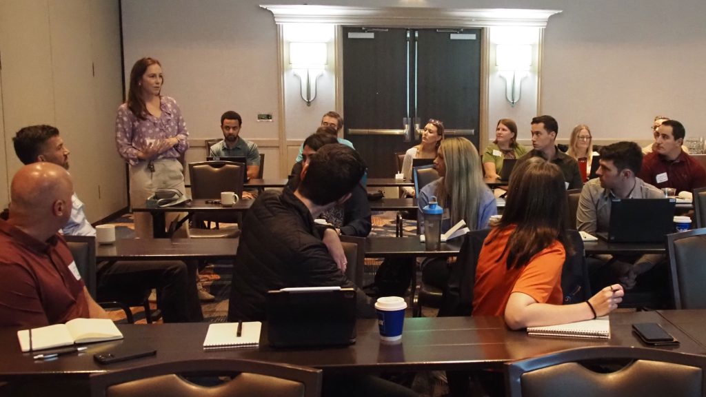 A Design® Training attendee speaking to the group from the back of the room